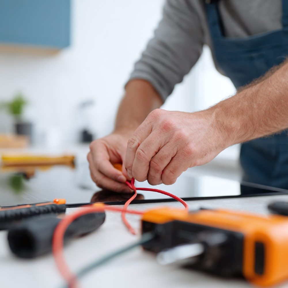 qwwrty5251_Electrician_connecting_an_induction_cooktop_in_a_m_5fa1b242-020f-4daf-82c3-80410587bca8_1 qwwrty5251_Electrician_connecting_an_induction_cooktop_in_a_m_5fa1b242-020f-4daf-82c3-80410587bca8_1